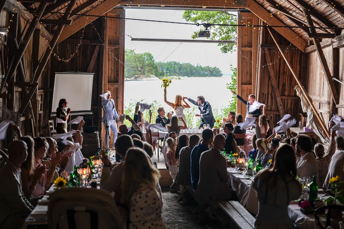 Wedding party in a barn by the water